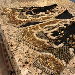 Sequined black and gold short evening jacket.